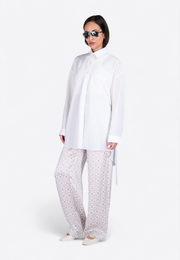 Model wearing fabric belted linen shirt, front-side view – East Vibe